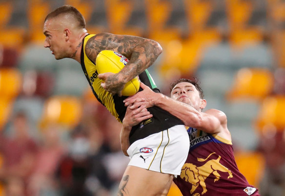 Two champs: Dustin Martin is tackled by Lachie Neale.