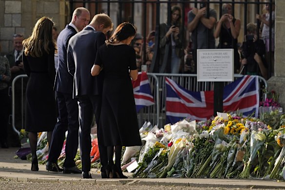 Prince William and Catherine, Princess of Wales, left, and Prince Harry and Meghan, Duchess of Sussex view the floral tributes for the late Queen Elizabeth II outside Windsor Castle.