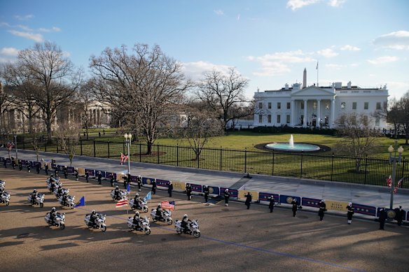 Metropolitan Police Department of the District of Columbia motorcycles pass the White House on Pennsylvania Avenue during the 59th presidential inauguration parade in Washington, D.C., U.S., on Wednesday, Jan. 20, 2021. Biden will propose a broad immigration overhaul on his first day as president, including a shortened pathway to U.S. citizenship for undocumented migrants - a complete reversal from Donald Trump's immigration restrictions and crackdowns, but one that faces major roadblocks in Congress. 