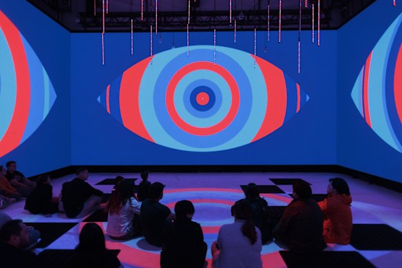 People watch the display at Vivid House as Vivid lights up for 2022  