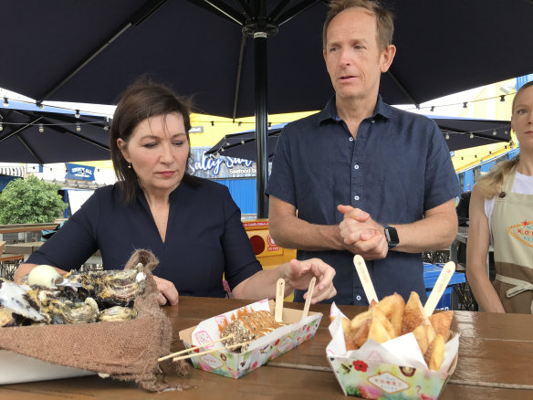 Environment Minister Leeanne Enoch and Eat Street’s John Harrison inspect cups made from corn starch and biodegradable utensils.