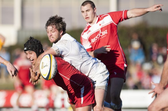 Vikings' Dean Oakman-Hunt offloads the ball while being tackled by Queanbeyan's Zac Tarrant.