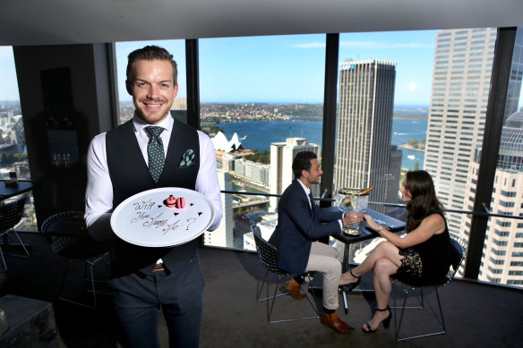 Floor manager Thomas Philbin-Malucelli with a special dessert prepared by the staff of the O Bar and Dining in Sydney's CBD. 