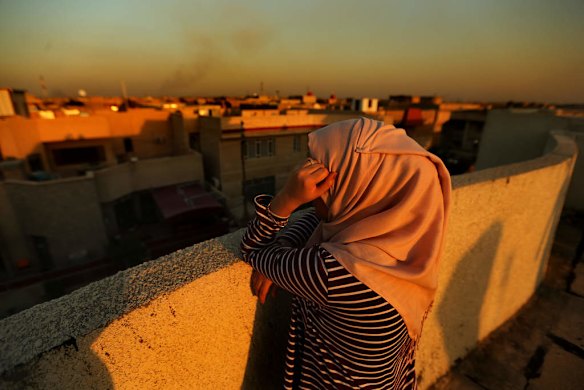 A female internally displaced person (IDP) from Fallujah on a rooftop overlooking Baghdad, Iraq. This woman lived in Fallujah when the Islamic State, also known as ISIS, took over Fallujah. She still has relatives in Fallujah which is still under ISIS control. Baghda, Iraq.