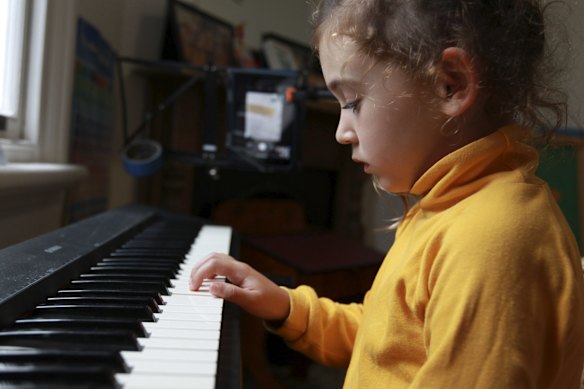 Florence has an online piano lesson after a day of homeschooling.