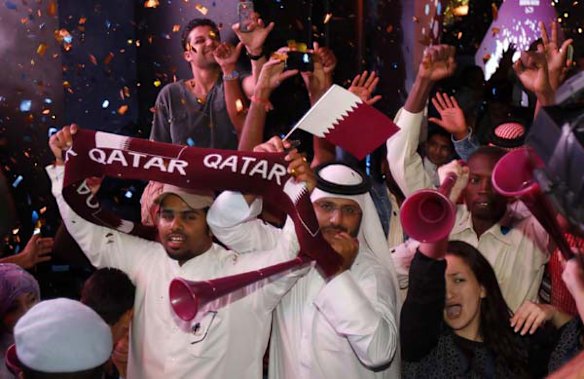Qatari fans celebrate at Souk Waqif in Doha.