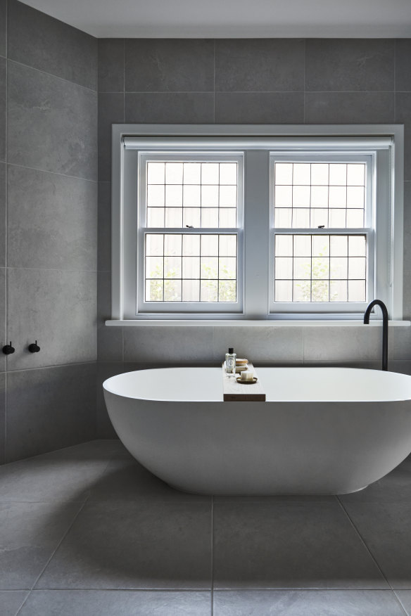 A former study was transformed into a spacious bathroom as part of the main bedroom suite. The stone “Moda” bath is from ACS Designer Bathrooms.