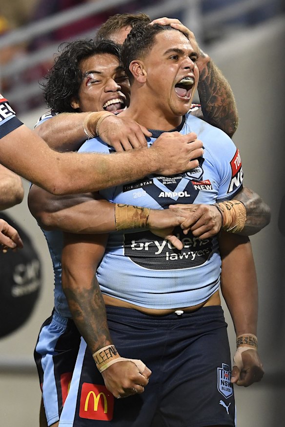 Latrell Mitchell of the Blues celebrates with team mates after scoring a try during game one.