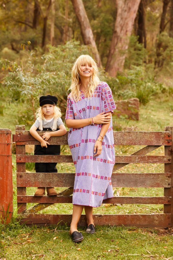 Anna wears Pippa Holt kaftan, $1435 from Pam Pam; UGG Tamara slides, $139.95. Banjo wears French stripe tee, $25 from Mamapapa; Little Creative Factory overalls, $150 from Mamapapa; Little Creative Factory hat, $75 from Mamapapa; and UGG Adoria Tehuano boots, $139.95.
