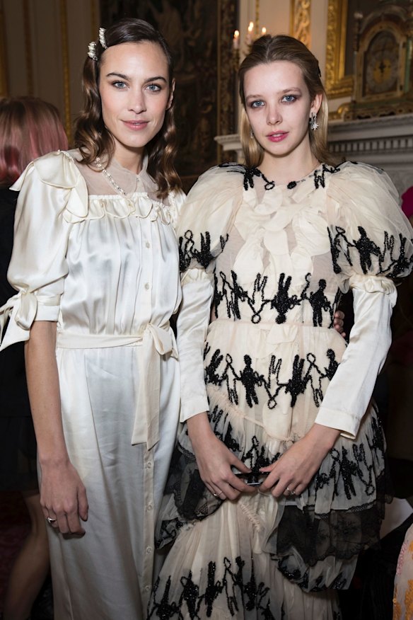 From left, Alexa Chung and Greta Bellamacina pose for photographers before the Simone Rocha Autumn/Winter 2018 fashion week runway show in London.