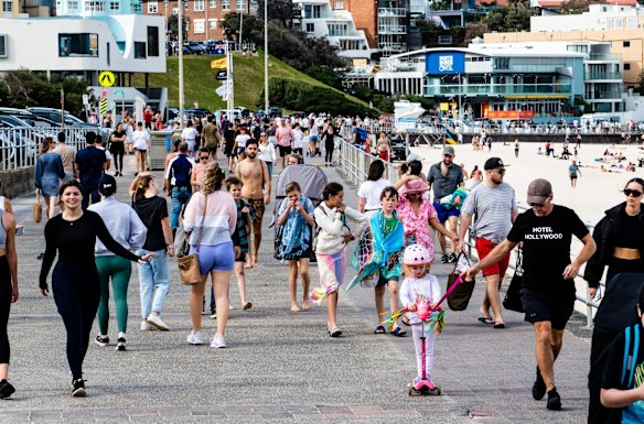 People enjoying warm weather at Bondi Beach in early August.