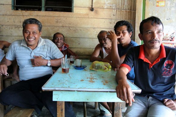 The men of Batukatak, near Bukit Lawang, North Sumatra, discuss the potential for eco-tourism at the only cafe in their village.