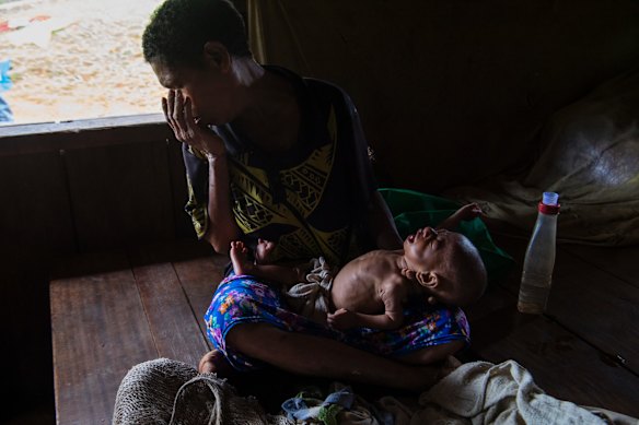 Habusimi Gahanabea with her five-month-old baby Nidoo. Both are suspected to have tuberculosis.