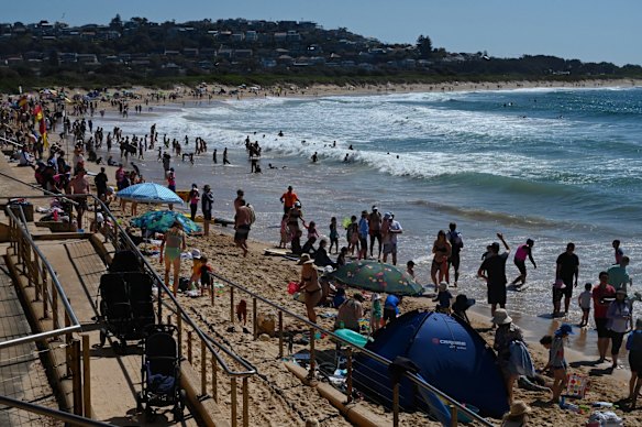 Busy Dee Why Beach on warm long weekend Monday.