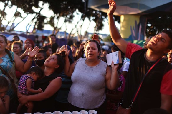 Asylum-seeking migrants worship during an impromptu service at a makeshift camp on the Mexican side of the San Ysidro Port of Entry in Tijuana, Mexico.