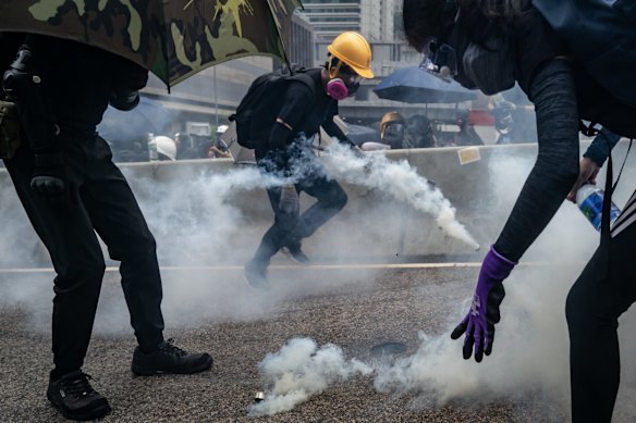 Protesters in a cloud of tear gas during a clash with police at an anti-government rally outside of the Central Government Complex.