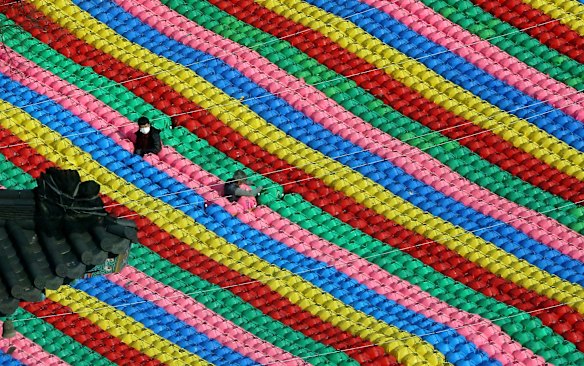 Workers adjust lanterns for upcoming celebration of Buddha's birthday on May 22 at Jogye temple in Seoul, South Korea.