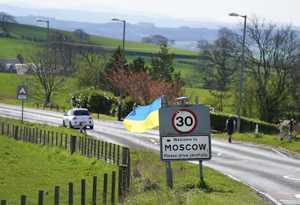 The flag of Ukraine flies on the sign for village of Moscow in East Ayrshire in England.
