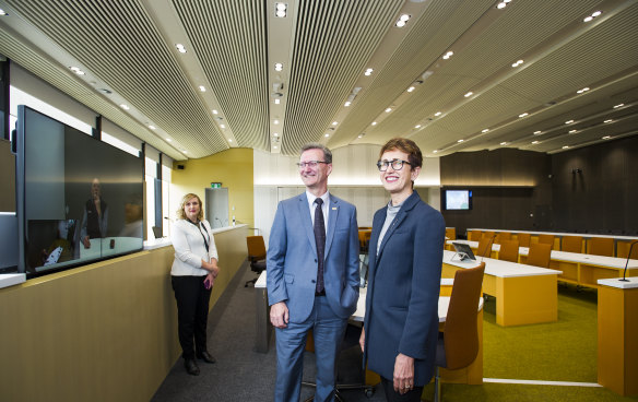 Chief Justice, Helen Murrell shows attorney general, Gordon Ramsay around the new court room's advanced technology. Pictured with in court technology officer, Drani Sarkozi.