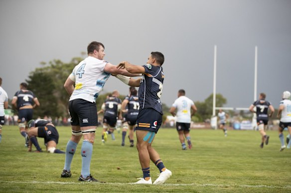 The Waratahs' Jed Holloway gets in the face of the Brumbies' Wharenui Hawera. 