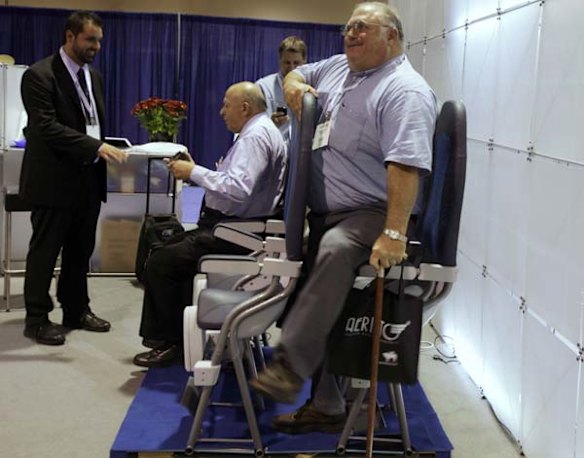 A man tries out Italian company Aviointeriors' new 'Skyrider' seat which has just 23 inches of legroom.