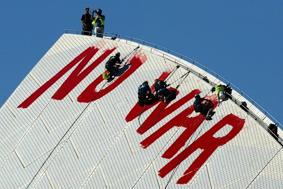Workmen attempting to remove the Anti War graffiti  NO WAR from the Sydney Opera House.
