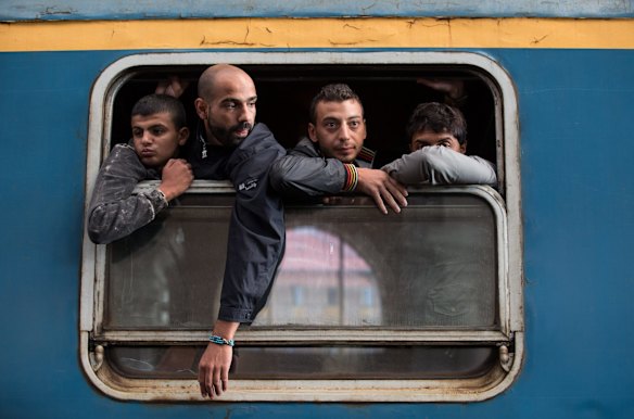 Migrants board a train in Keleti station after it was reopened this morning in central Budapest.