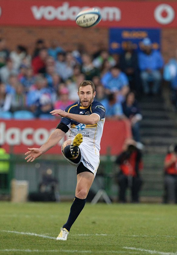 Nic White of Brumbies kicks upfield.