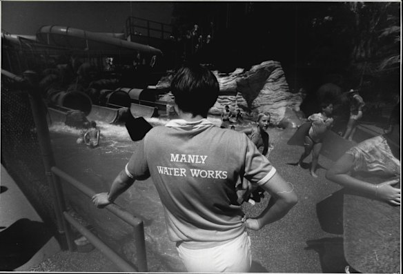 An attendant at the Manly Waterworks looks on as the children get out of the water on December 20, 1985.  Manly Waterworks was also the site of the filming for BMX bandits - an early Nicole Kidman film.
