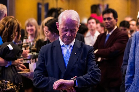 Former Coalition cabinet minister Philip Ruddock checks the time at The Fullerton Hotel, Sydney, as the results of the federal election look increasingly grim for the Liberals.