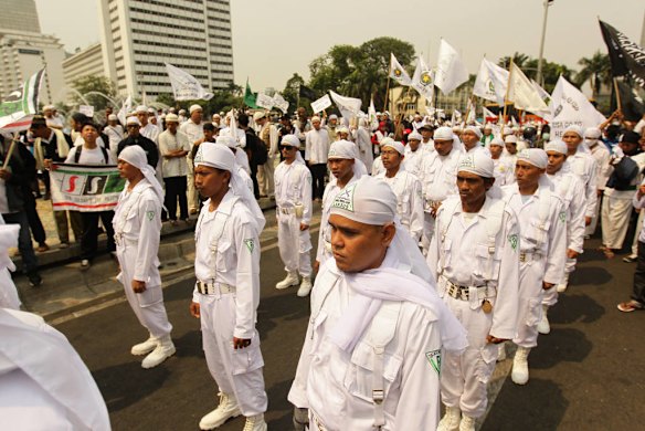 Islamic Defenders Front (FPI) an islamic militant group join protestors gathering for anti US protests at the Bunderan Hotel Indonesia traffic circle in Central Jakarta, Indonesia.