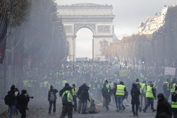 A cloud of tear gas fills the air on the streets of Paris. 