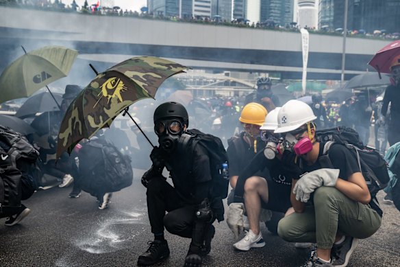 Protesters standoff with police in cloud of tear gas during a clash at an anti-government rally outside of the Central Government Complex.