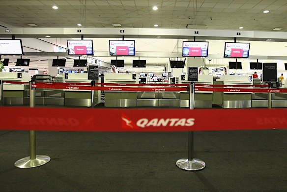 The Qantas check in area is seen empty at Sydney International Airport on Sunday.