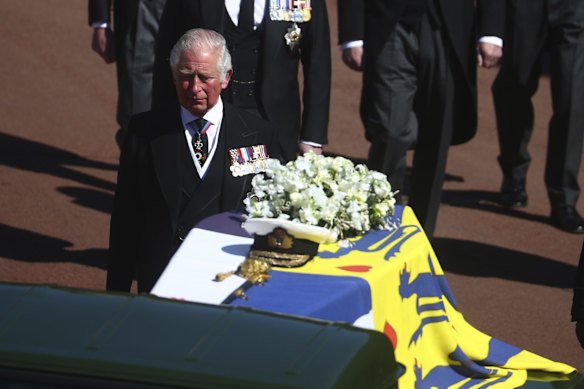 Prince Charles follows the coffin.