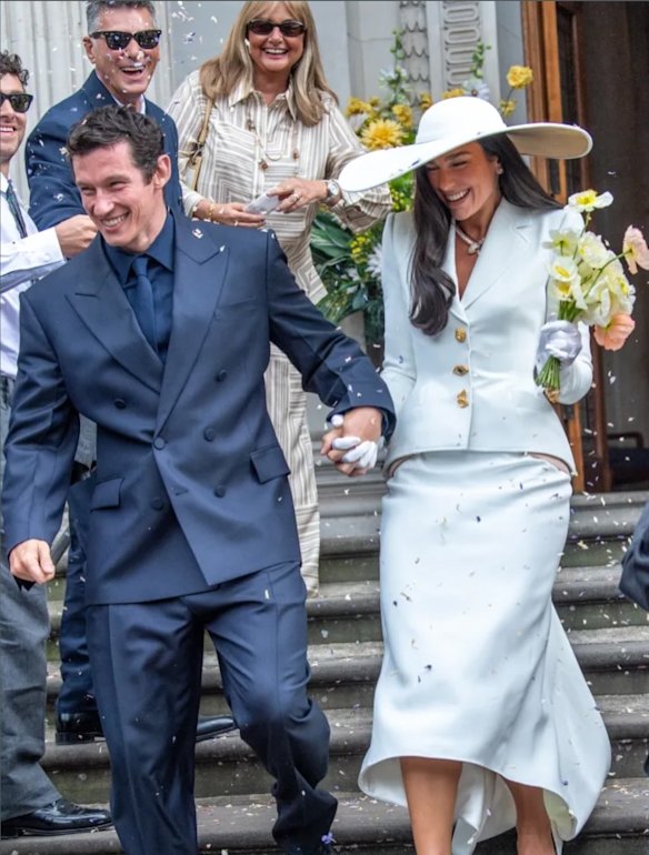 Callum Turner, in a Ferragamo suit, and Dua Lipa leaving the registry office following their wedding at the weekend.