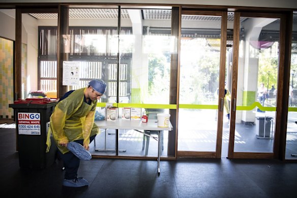 Nurse Jarrod Tunks suits up ahead of a day of testing.