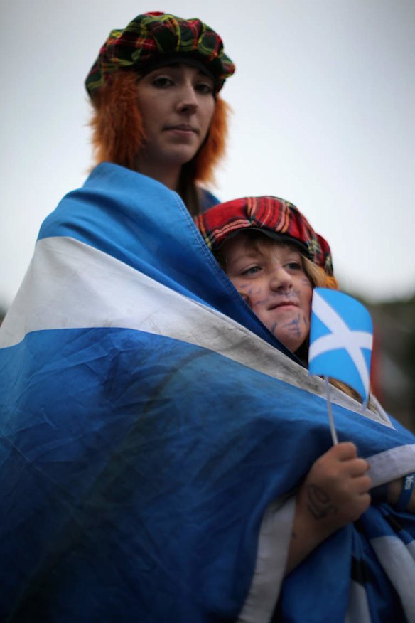Debbie Ramsay, aged 24 and Gian Smith, aged eight, wait outside the Scottish Parliament as voting in the referendum continues.