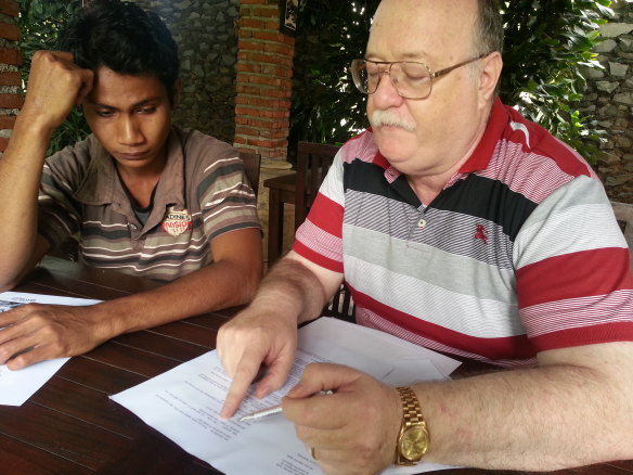 Colin Singer (right) explaining legal documents to Ali Jasmin at a restaurant in Bandung, Indonesia, in 2014.  