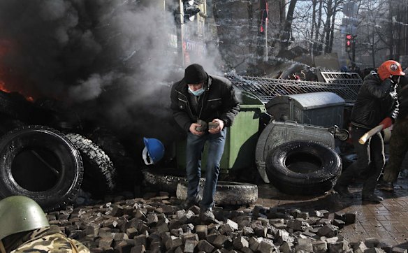 Anti-government protesters clash with riot police outside Ukraine's parliament in Kiev, Ukraine, Tuesday, Feb. 18, 2014. Ukraine's festering political crisis took a deadly turn Tuesday, as thousands of anti-government protesters clashed with police outside Ukraine's parliament. Three protesters were killed in the melee, the opposition reported, and emergency workers found another person dead after a fire at the ruling party's office in Kiev. Law enforcement agencies gave the demonstrators a deadline of 6 p.m. (1600 GMT) to stop the confrontations and vowed to restore order.