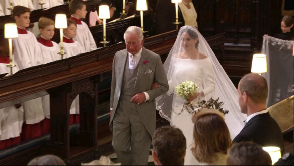 Meghan Markle walks down the aisle with Prince Charles.