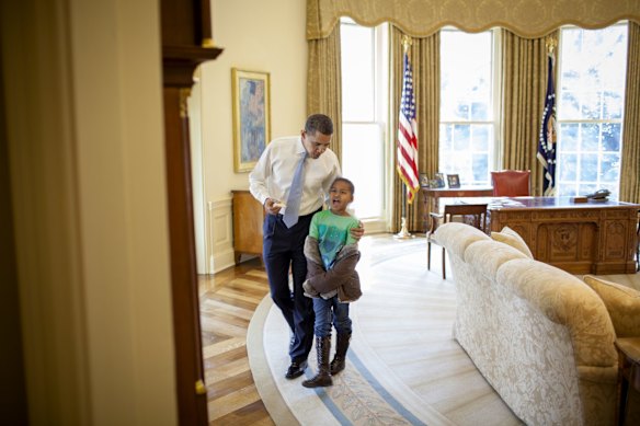 Sasha Obama stops by to say hi to her dad, President Obama in the Oval Office of the White House in Washington.
