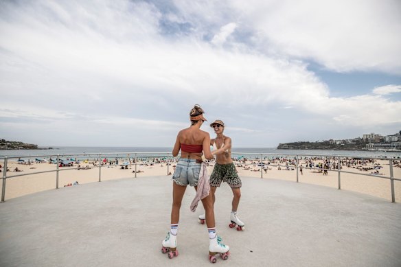 Friends Harriot Smith and Gina Bresciani rollerskate through Bondi Beach.