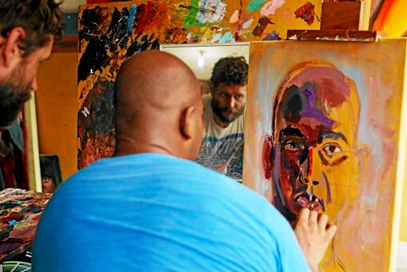 Australian artist Ben Quilty watches Bali Nine member Myuran Sukumaran as he paints during a lesson in Kerobokan jail.