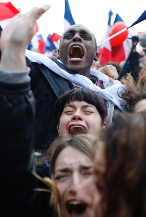 Supporters of French independent centrist presidential candidate, Emmanuel Macron react outside the Louvre museum in Paris, France.