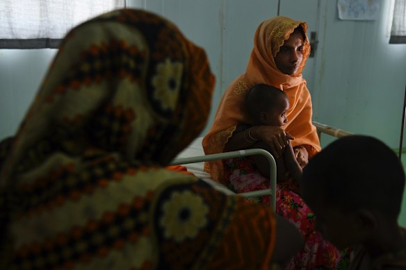 Khadiza 22 (2nd from right) holds her son Mohammad Haris aged 1 (2nd from left) who is being treated for malnutrition at the Medecins Sans Frontieres hospital in the Kutupalong Camp.