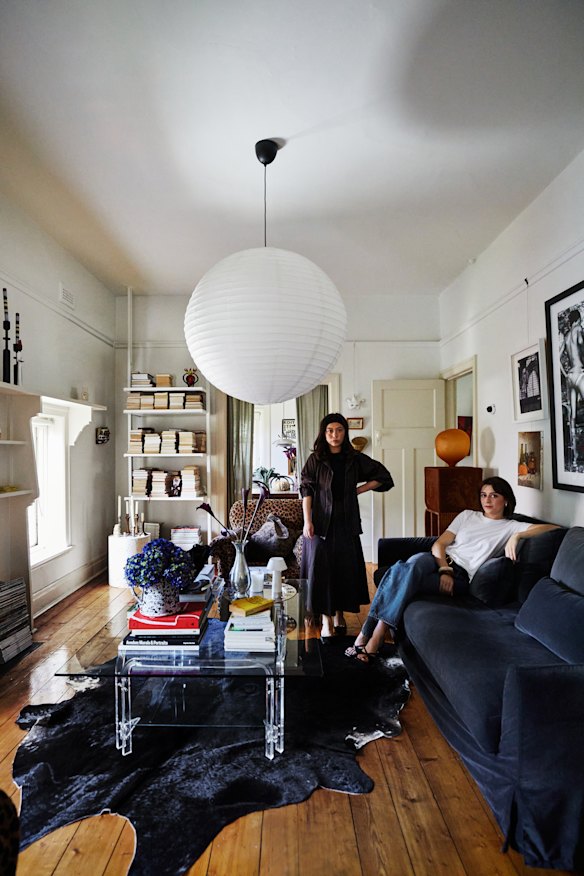 Nicole Williams (left) and Reinette Roux in their lounge room. The glass and lucite coffee table was purchased from a friend.