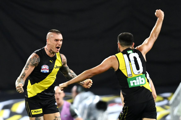 Dustin Martin of the Tigers celebrates kicking a goal with teammate Shane Edwards.