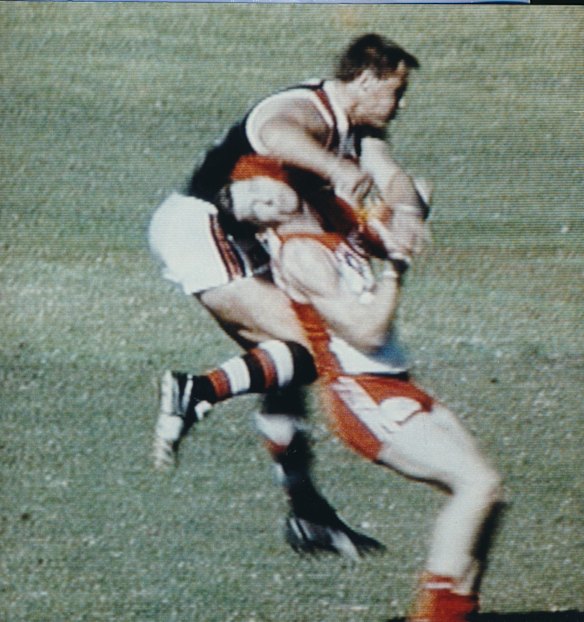 Tony Lockett clashes with Peter Caven.