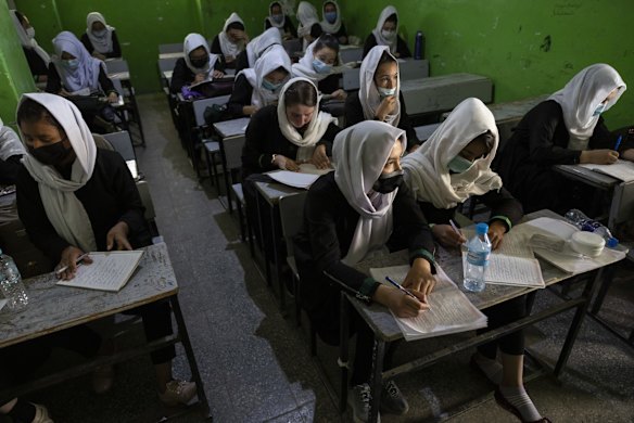 Afghan female students listen during 10th grade class at the Zarghoona high school on July 25 2021 in Kabul, Afghanistan. The Zarghoona girls high school is the largest in Kabul with 8,500 female students attending classes. The school opened after almost a two months break due to Coronavirus. Currently there is widespread fear that the Taliban who already control around half the country will reintroduce its notorious system barring girls and women from almost all work, and access to education. The Ministry of Education has announced the opening of schools, but there are  mixed reports in many areas where the Taliban have taken control or where fighting is ongoing.